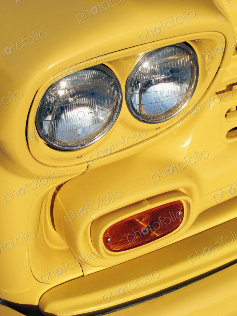 Yellow bodywork and vehicle lights on a school bus