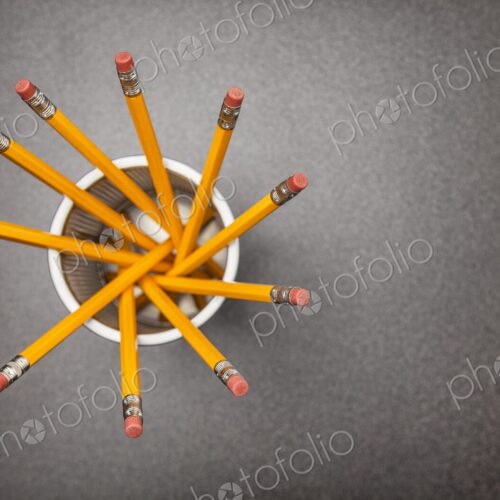 Yellow no.2 pencils in cup on desk in business office or school, view from above Yellow no.2 pencils in cup on desk in business office or school, view from above