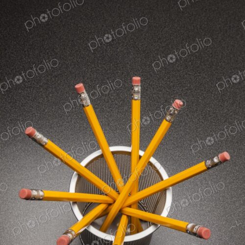 Yellow no.2 pencils in cup on desk in business office or school, view from above Yellow no.2 pencils in cup on desk in business office or school, view from above