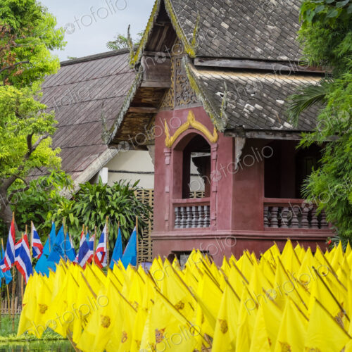 Yellow prayer flags in front of a wat temple, bright colours. Yellow prayer flags in front of a wat temple, bright colours.