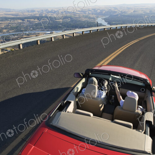 Young Caucasian couple on a road trip in their convertible sports car near Lewiston,…