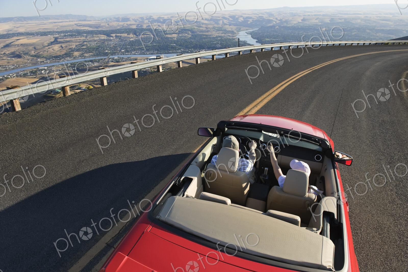 Young Caucasian couple on a road trip in their convertible sports car near Lewiston,…