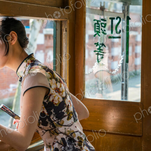 Young Chinese Woman in old tram, Shanghai, China Young Chinese Woman in old tram, Shanghai, China