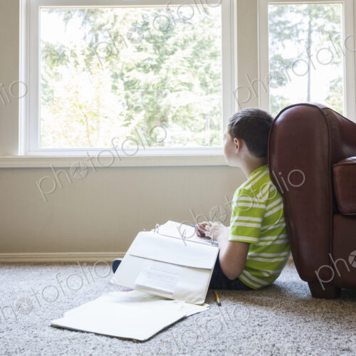 Young boy at home doing homework. Young boy at home doing homework.
