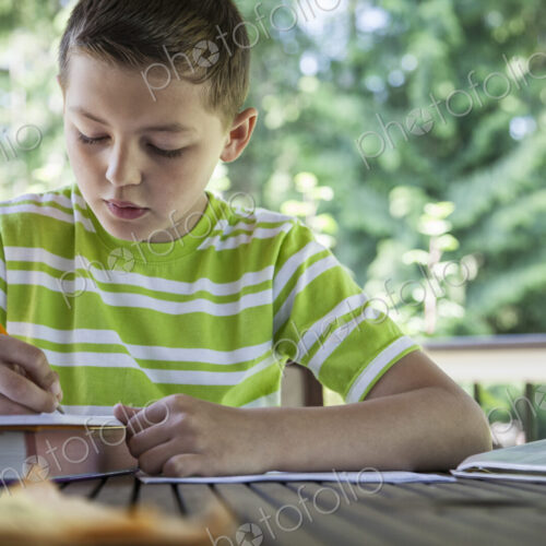 Young boy at home doing homework.