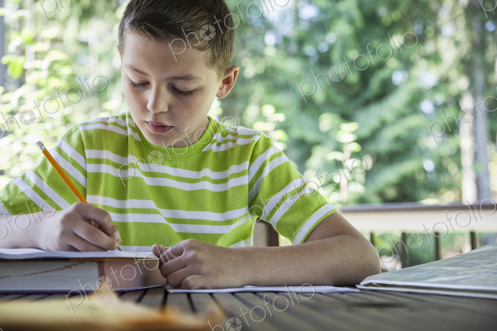 Young boy at home doing homework.