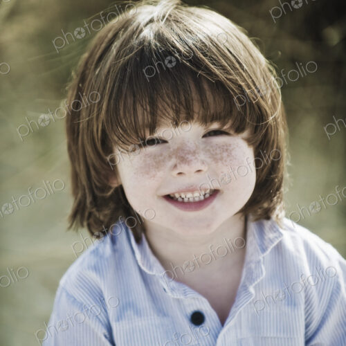 Young boy with brown hair and freckles, wearing blue shirt. Young boy with brown hair and freckles, wearing blue shirt.