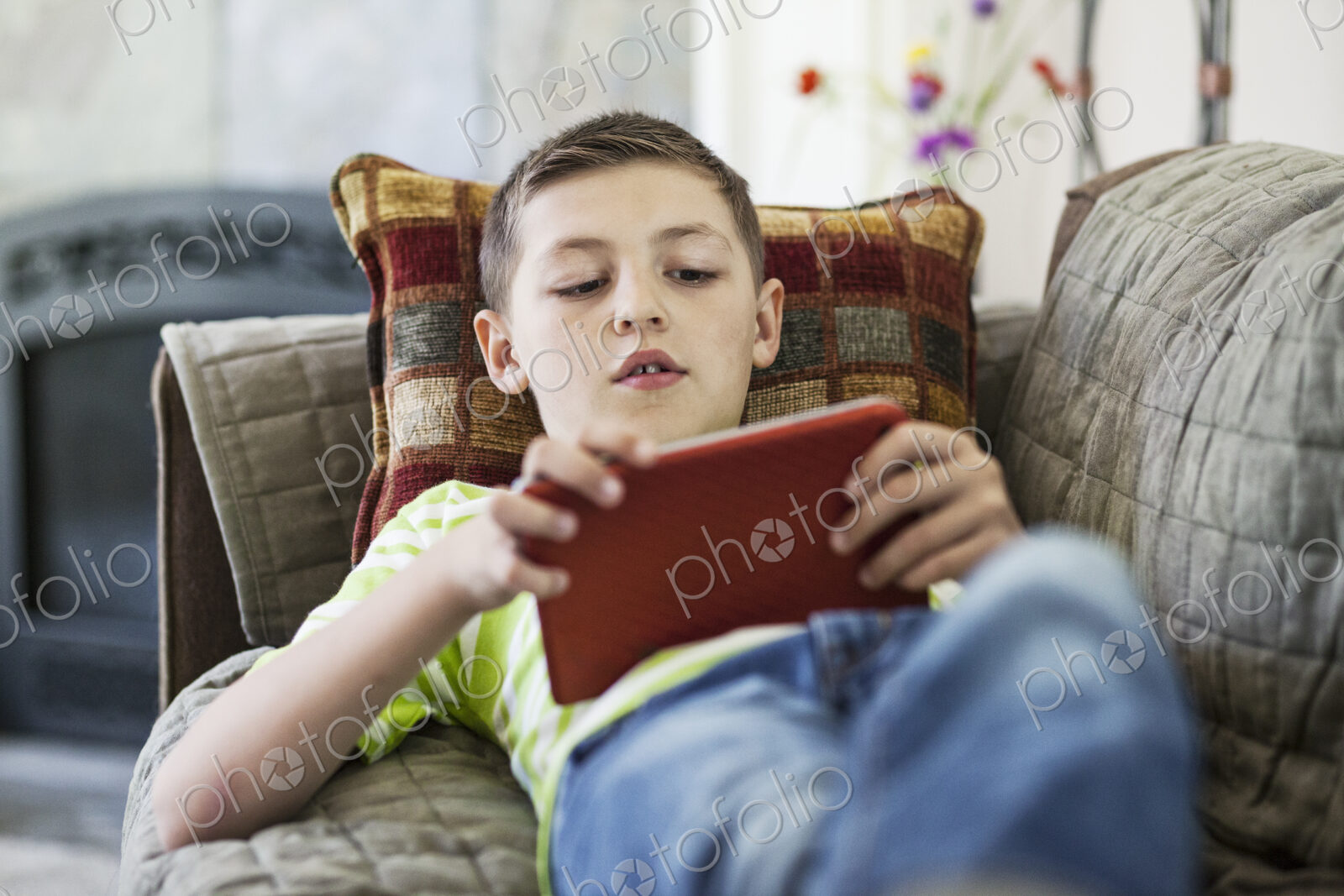 Young boy working on a notebook computer at home