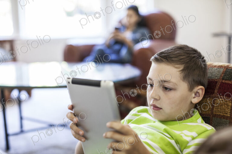 Young boy working on a notebook computer at home