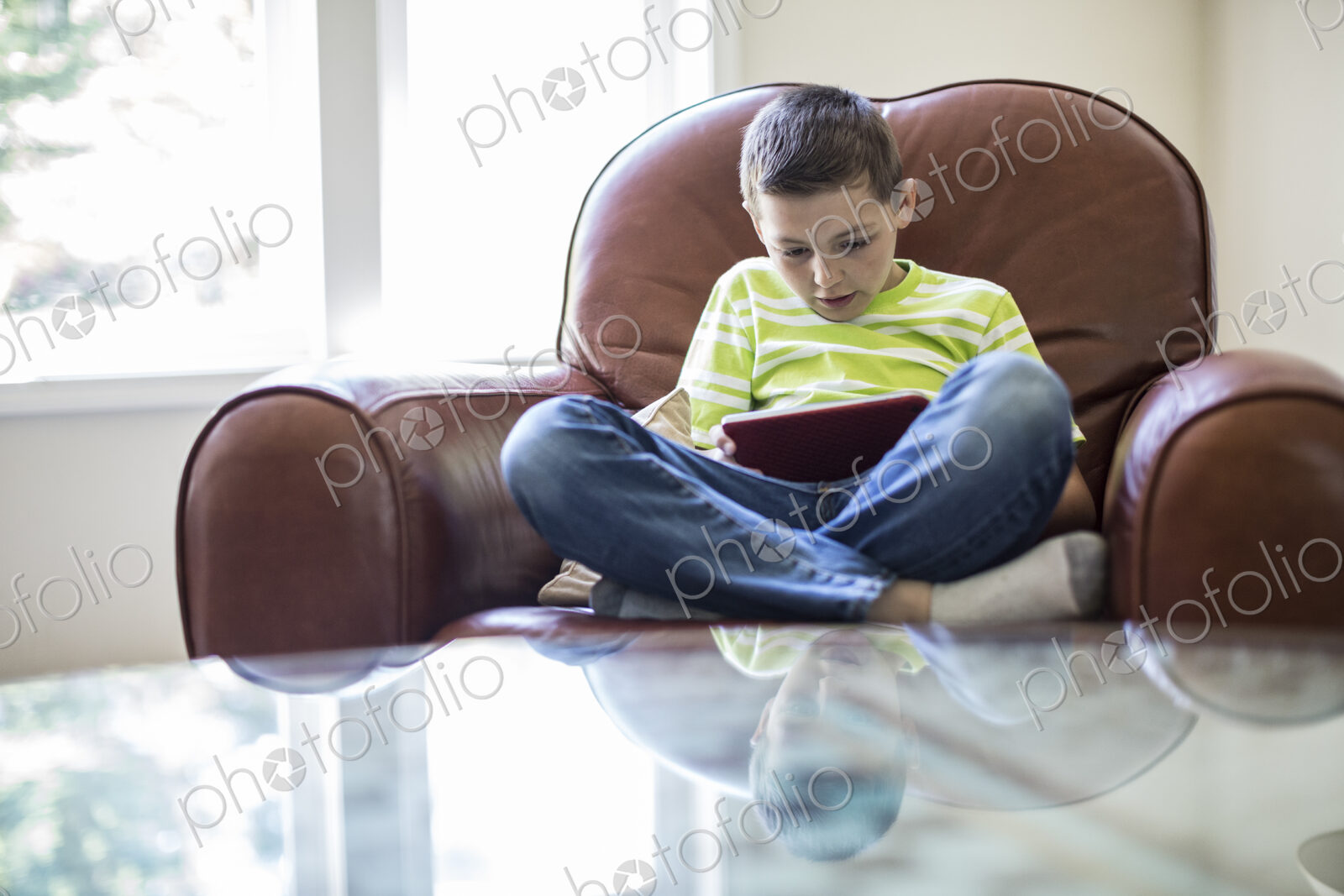 Young boy working on a notebook computer at home