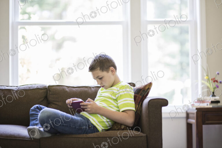 Young boy working on a notebook computer at home