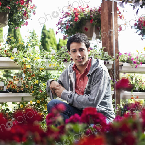 Young caucasian man employee of a garden center nursery. Young caucasian man employee of a garden center nursery.