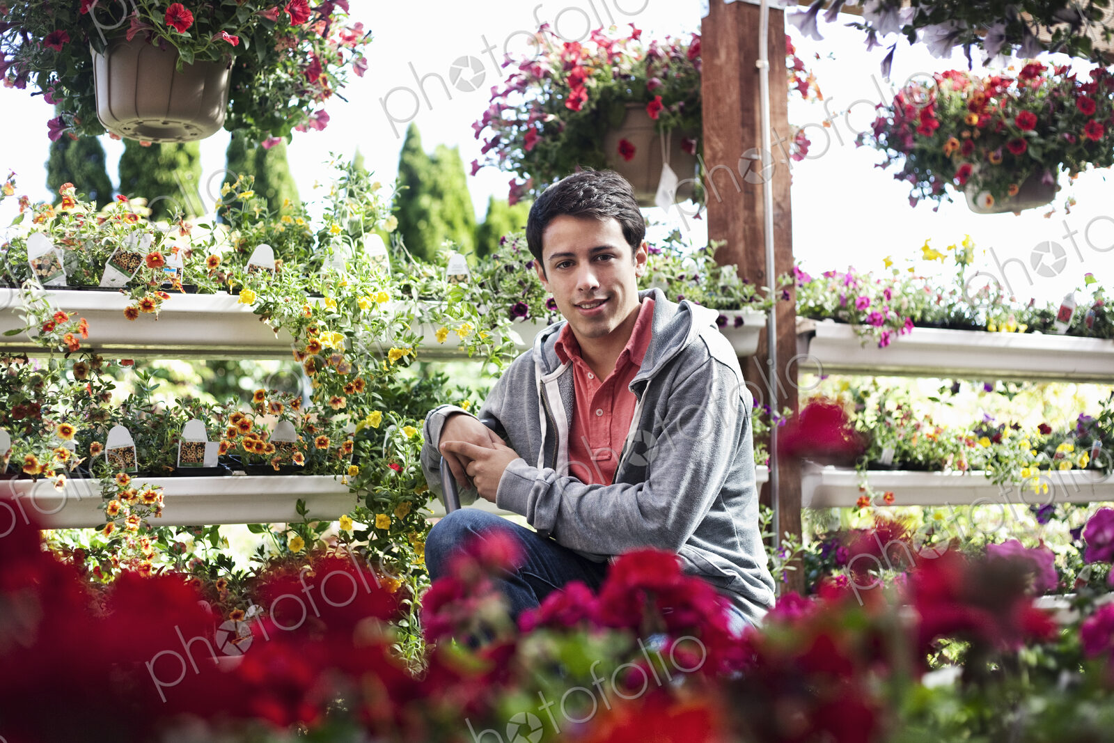 Young caucasian man employee of a garden center nursery.