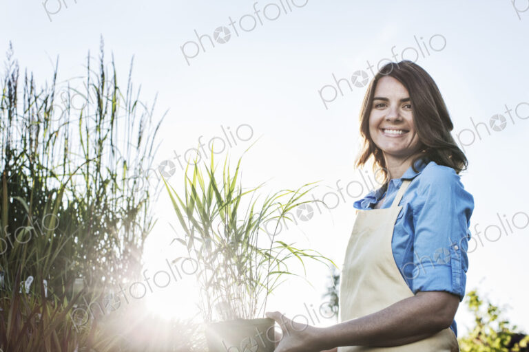 Young caucasian woman employee of a garden center and plant nursery.