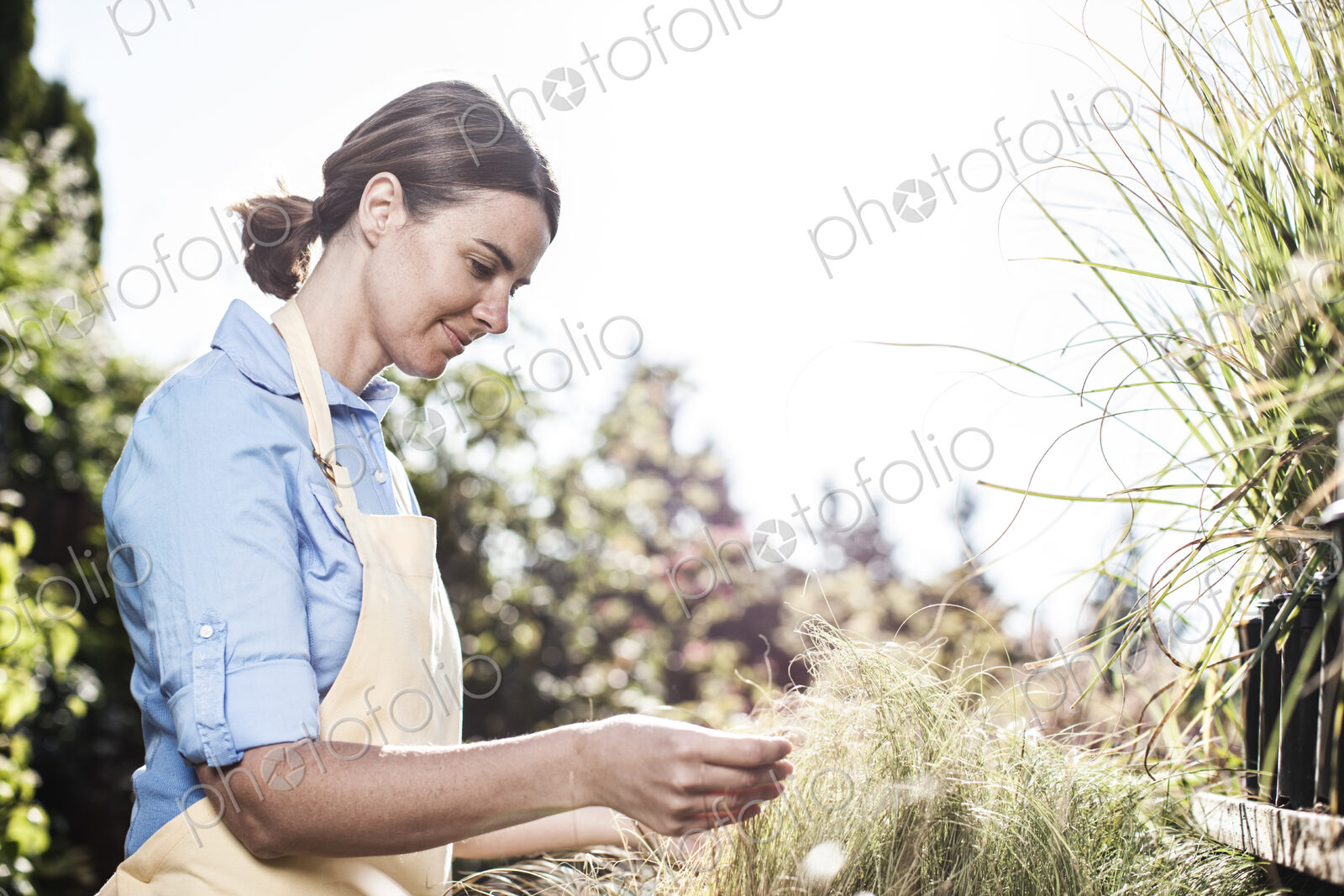 Young caucasian woman employee of a garden center nursery.
