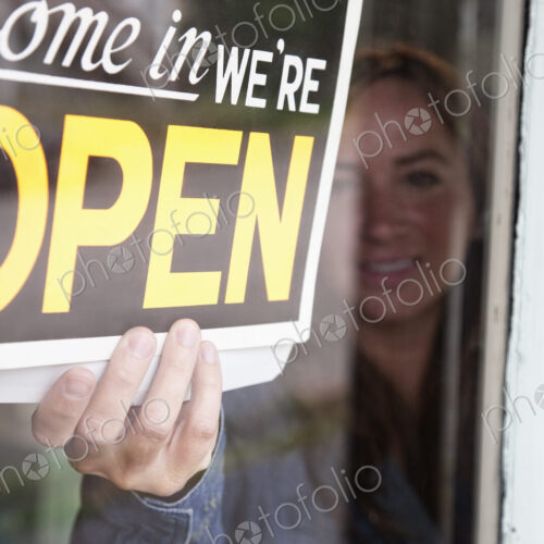 Young caucasian woman opens antique store for business Young caucasian woman opens antique store for business