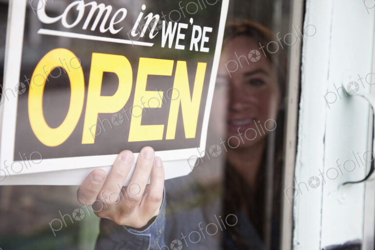 Young caucasian woman opens antique store for business