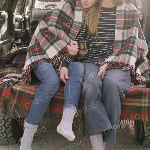 Young couple sitting in the back of their car. Young couple sitting in the back of their car.