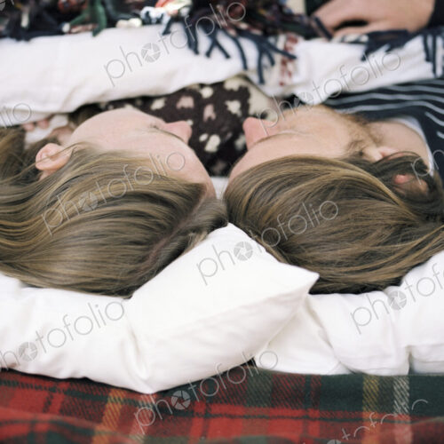 Young couple sleeping in the back of their car. Young couple sleeping in the back of their car.