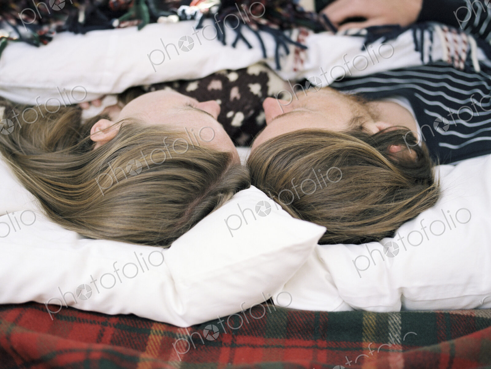 Young couple sleeping in the back of their car.