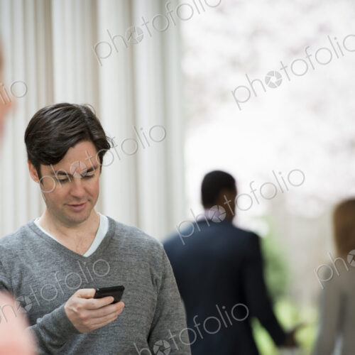 Young people outdoors on the city streets in springtime. Men and women.Two people, one… Young people outdoors on the city streets in springtime. Men and women.Two people, one…