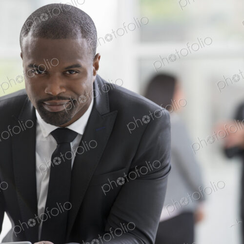 Young professionals at work. A man in a business suit, using a digital tablet. Young professionals at work. A man in a business suit, using a digital tablet.