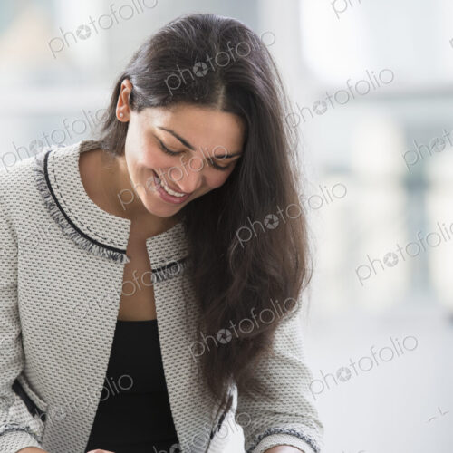 Young professionals at work. A woman at a work table using a digital tablet. Young professionals at work. A woman at a work table using a digital tablet.