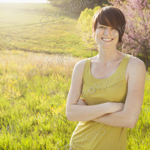 Young woman in grassy field in spring.