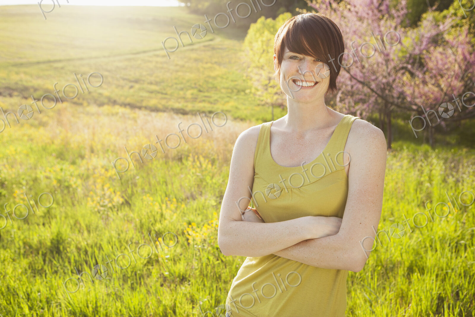 Young woman in grassy field in spring.