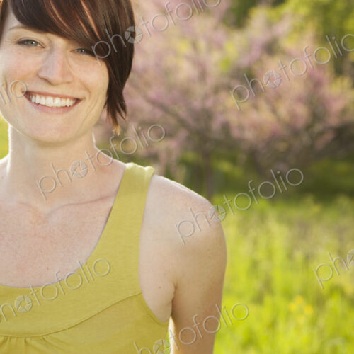 Young woman in grassy field in spring.