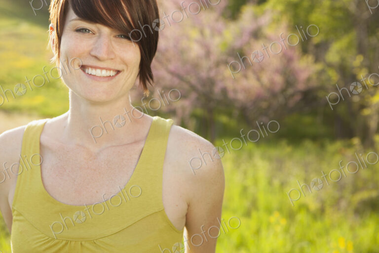 Young woman in grassy field in spring.