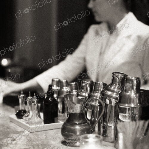 Young woman mixing a cocktail, Black and white image.