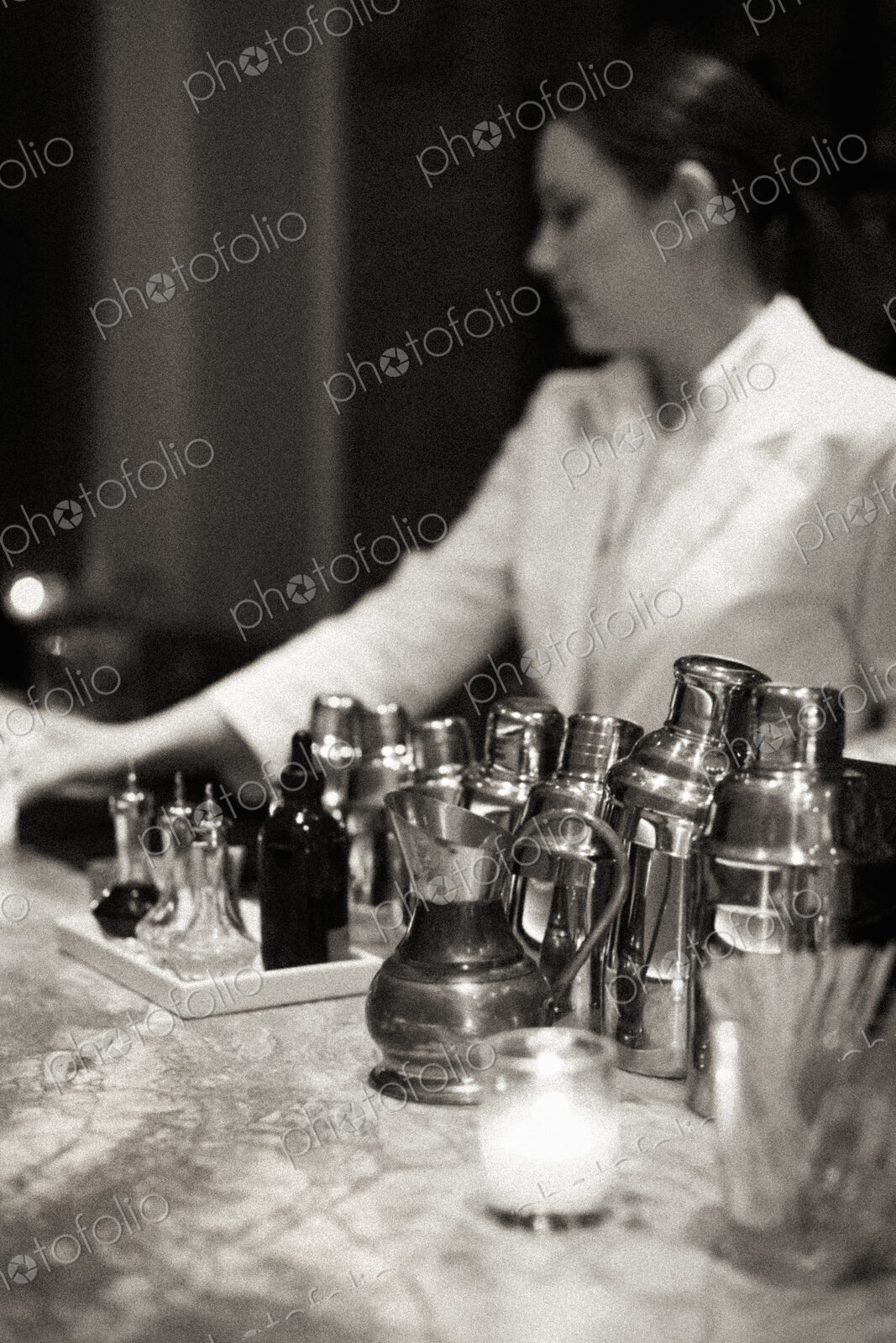 Young woman mixing a cocktail, Black and white image.