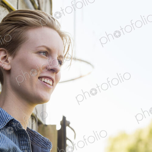 Young woman on a working farm, taking a break in the shade of a silo. Young woman on a working farm, taking a break in the shade of a silo.