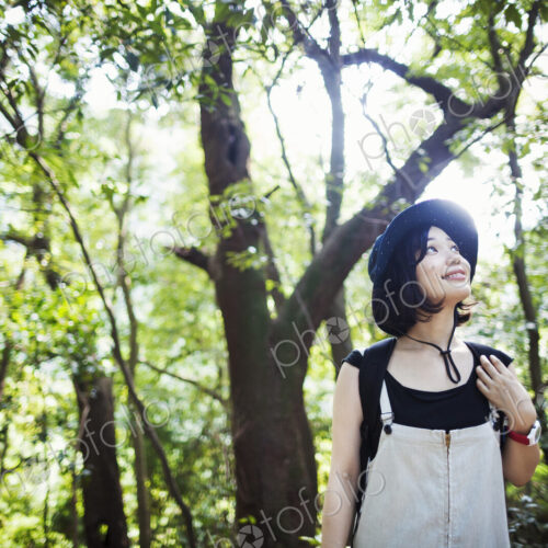 Young woman standing in a forest.