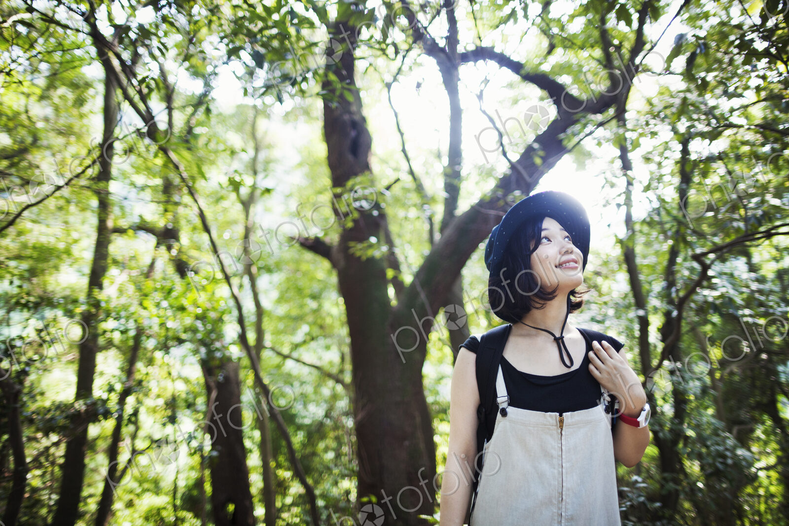 Young woman standing in a forest.