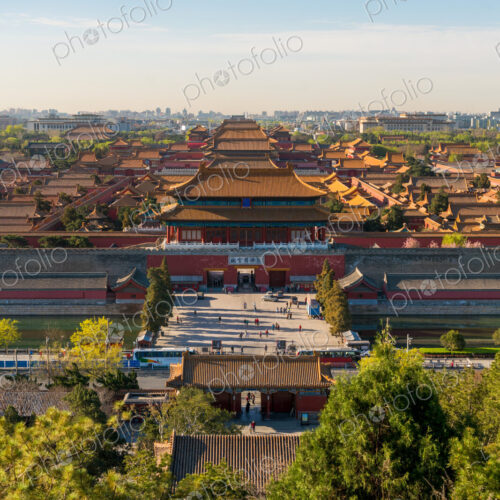 Young woman taking photograph of view over Forbidden City in Beijing, China Young woman taking photograph of view over Forbidden City in Beijing, China