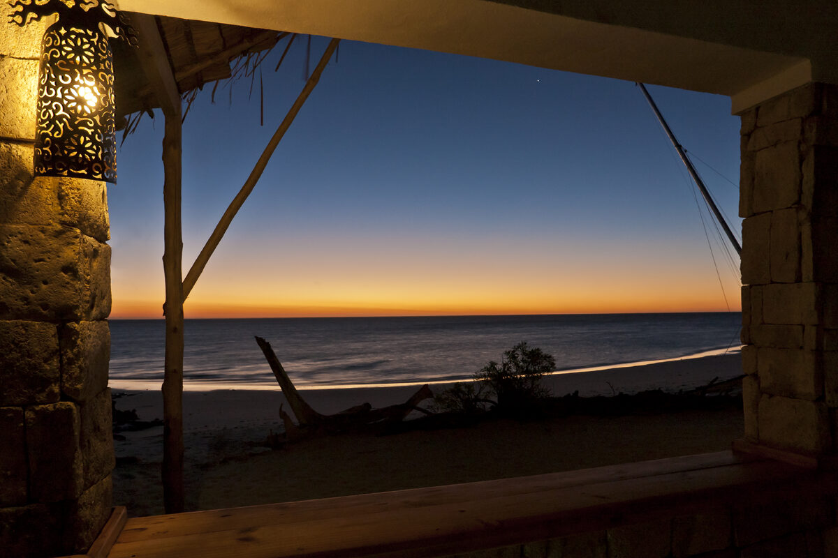 View of the sunset over the sea at a beach resort.