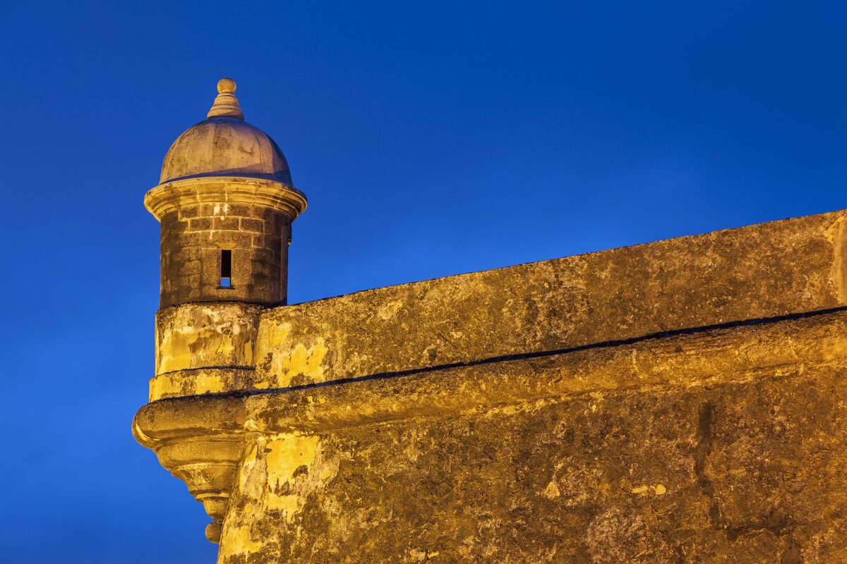 Travel category — Bathed in warm light against the vivid blue twilight sky, this historic garita-or… Bathed in warm light against the vivid blue twilight sky, this historic garita-or…